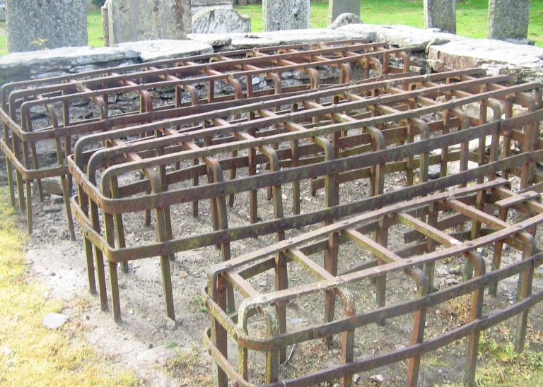 Metal cages built over graves.