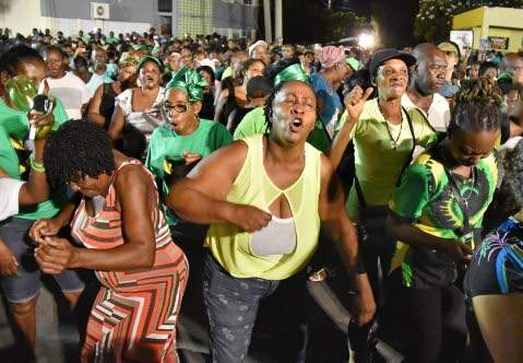 A crowd of people dancing and singing