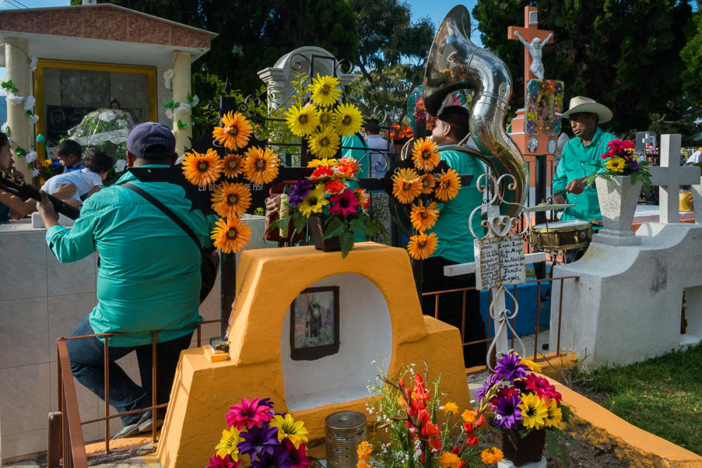 Musicians play music in a colorful cemetery.