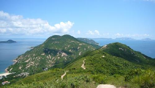 Photo of a landscape with green mountains.