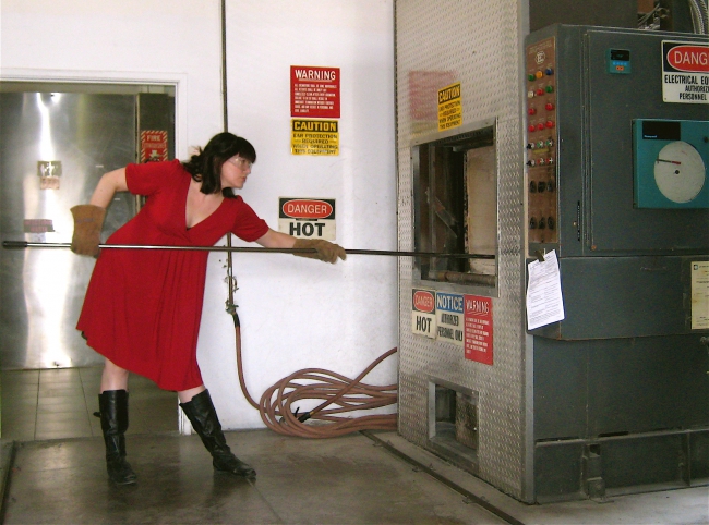 Caitlin Doughty using a cremation machine.