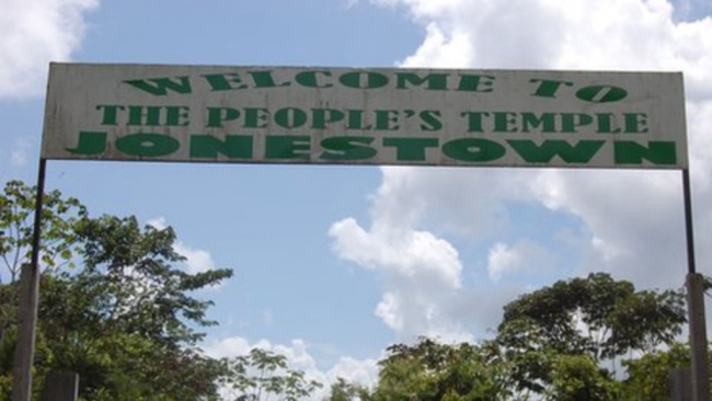 Photo of entrance sign at Jonestown that reads 