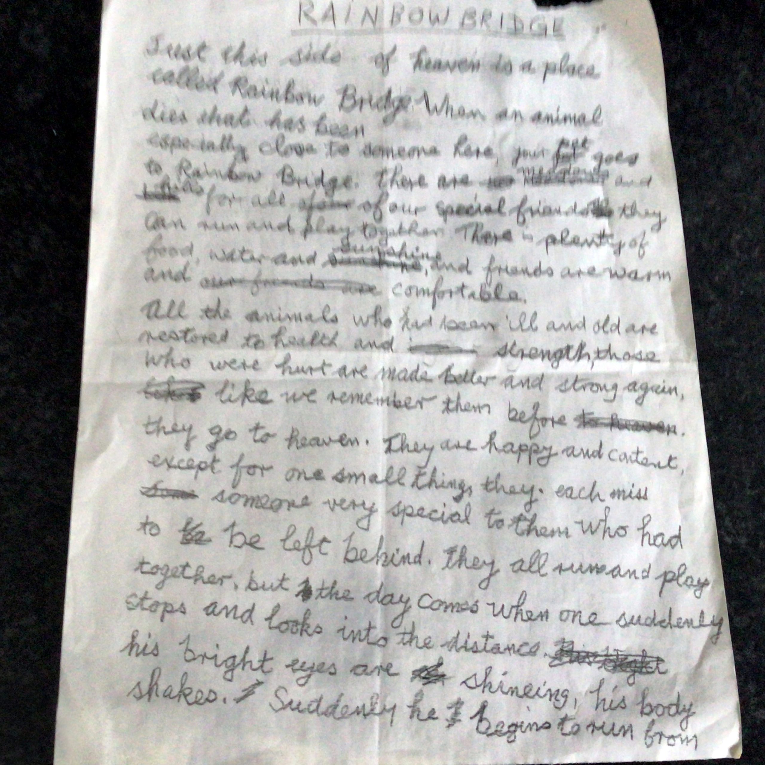 Edna's original writing of Rainbow Bridge, handwritten on a piece of white paper, with some words crossed out