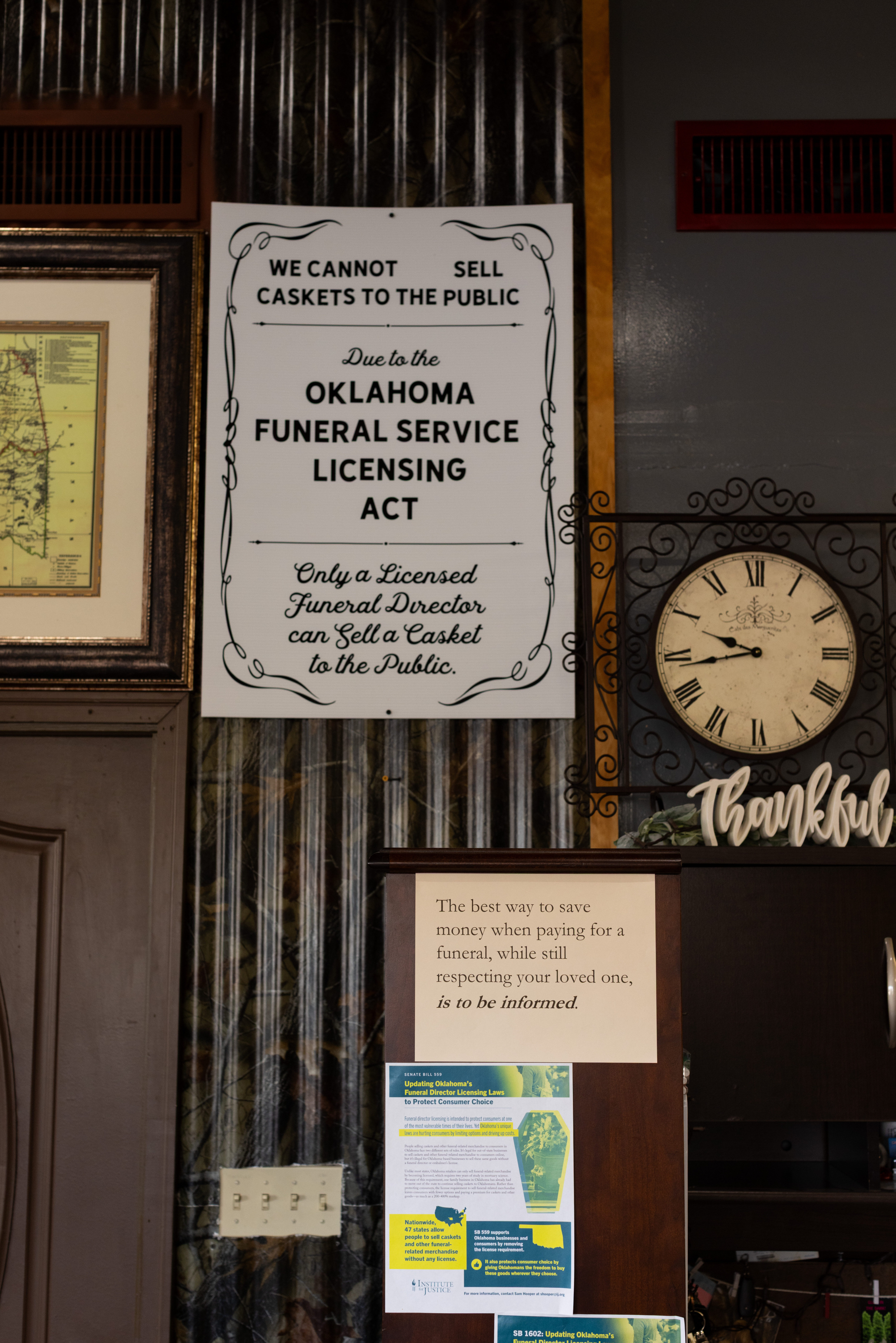 photo of a sign hanging in a casket workshop that warns the public that caskets cannot be sold due to funeral industry regulations