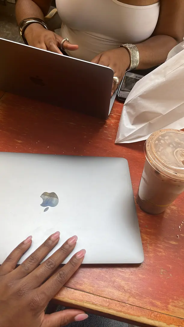 photo of a desk with 2 laptops, and coffee