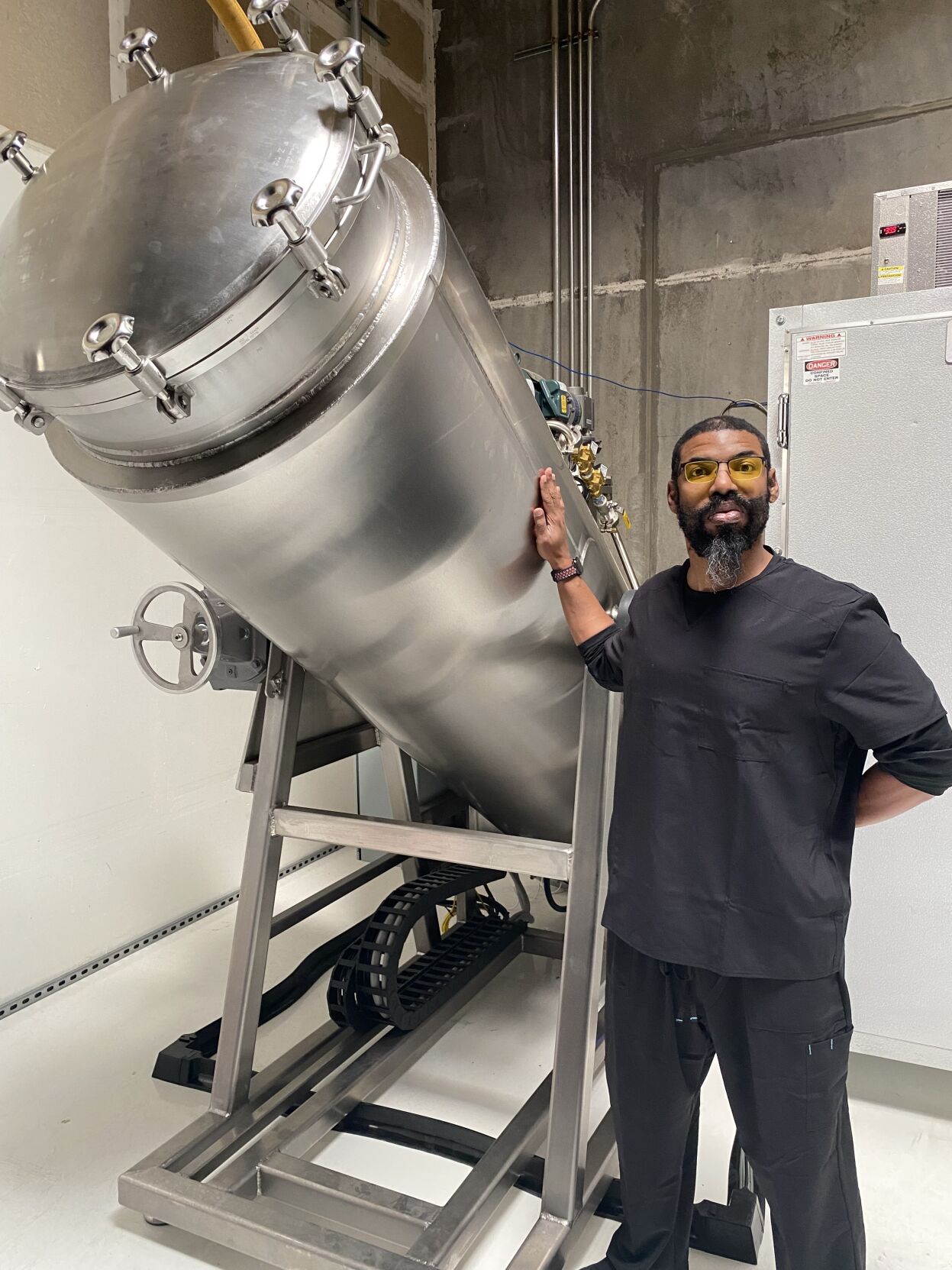 Man stands next to aquamation machine